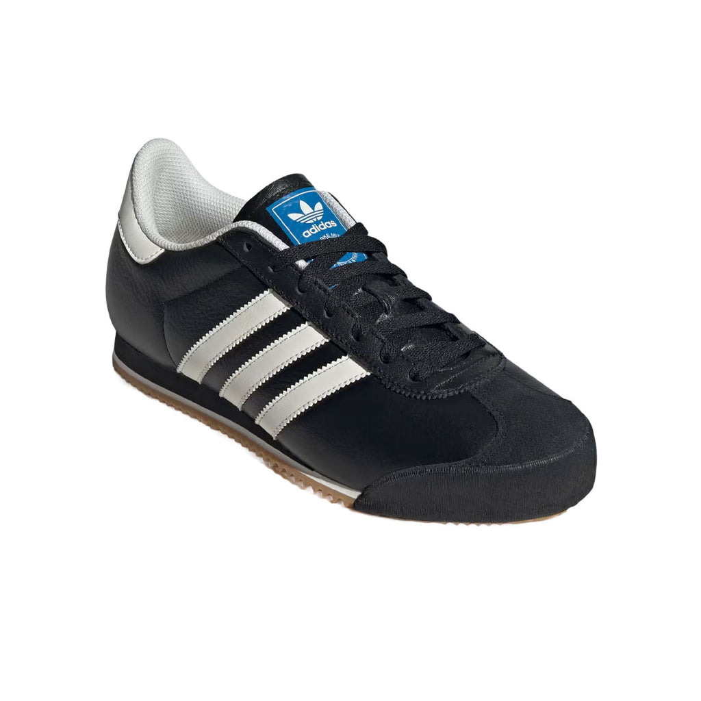 Adidas K74 herre walkersko i sort med hvide striber og blå detaljer
