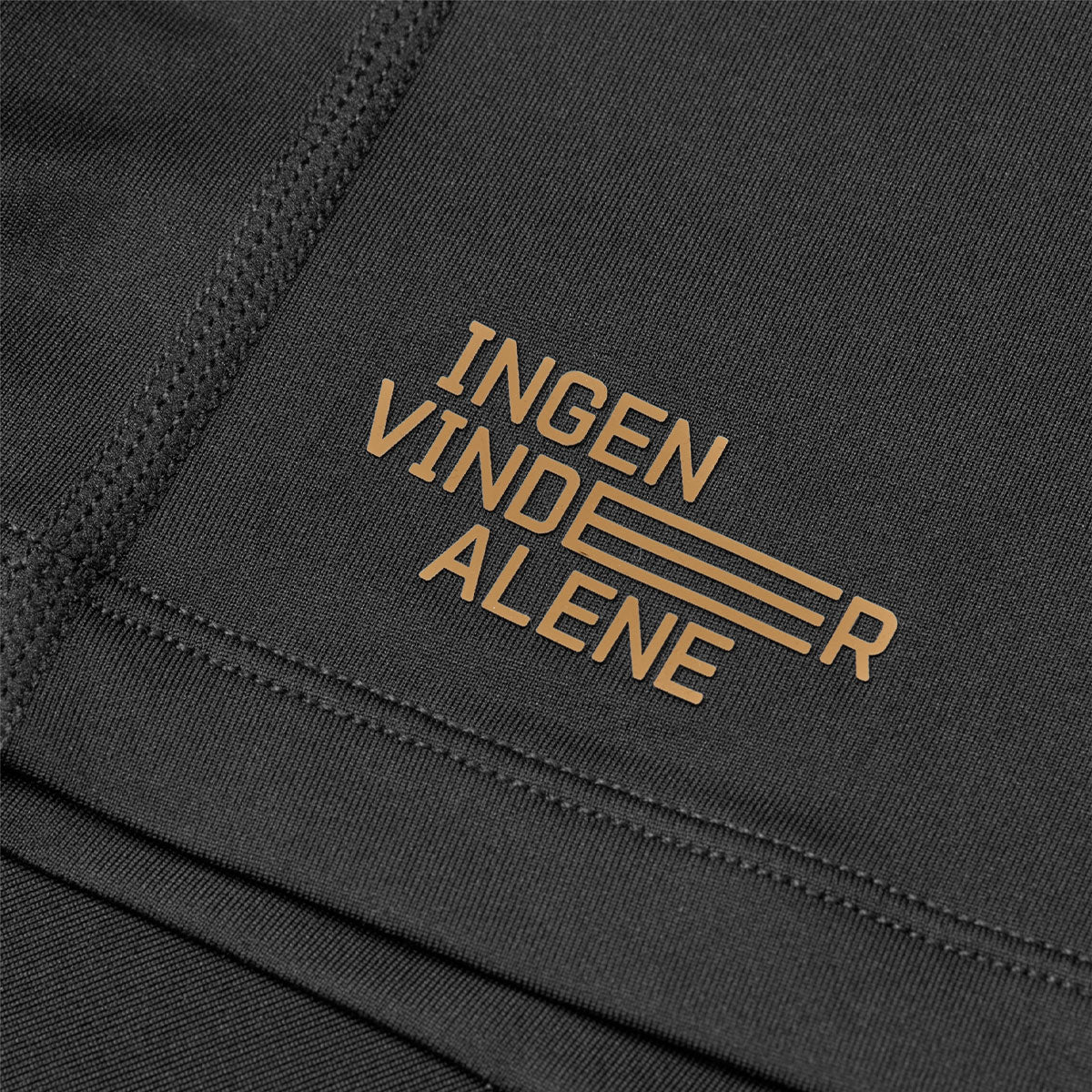 Sort T-shirt med teksten "Ingen vinder alene" i guldtryk
