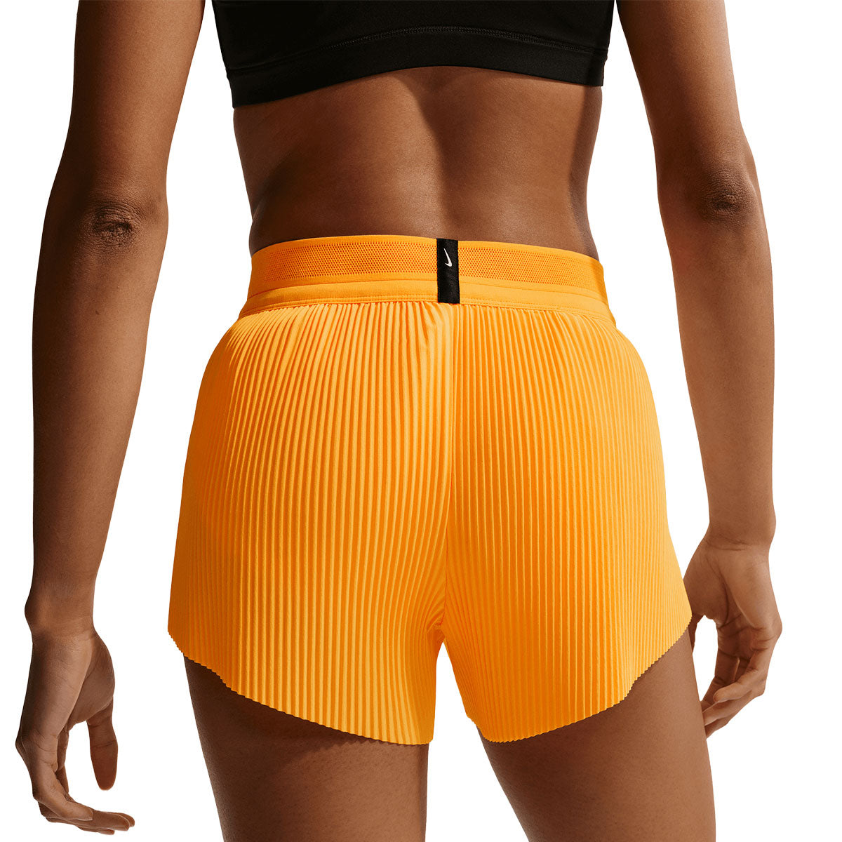 Nike AeroSwift Mid-Rise 3in shorts i orange med plisseringer